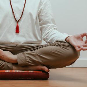 Close-up of hands in a meditative mudra position.